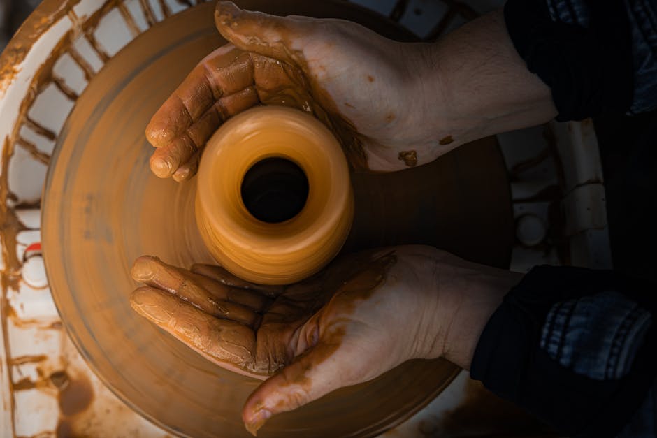 pottery wheel hands shaping clay
